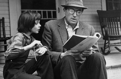 Gregory Peck reading book with Scout. 