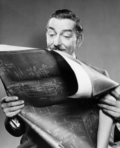 Vintage man holding blueprints.