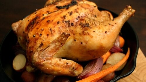 In the kitchen, master the fundamentals of cooking by preparing a delicious whole roasted chicken with tender carrots and crispy potatoes in a cast iron skillet.