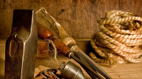 A craft of tools on a wooden table.