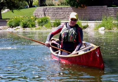 A man in the canoe wearing yellow cap.