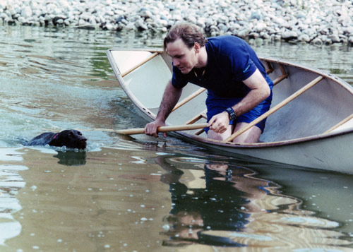 A drowning dog and a man in the boat.