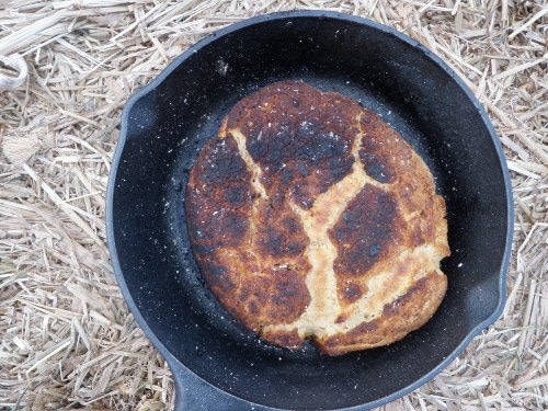 making bannock bread outdoors in cast iron skillet 