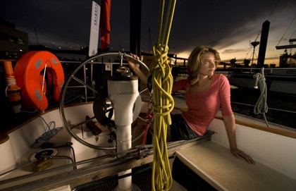 Jessica Watson sitting on sailboat. 