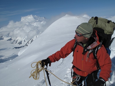 Eric Larson hiking on mountain peak. 