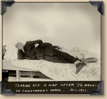 An old photograph of a man napping on a bed.