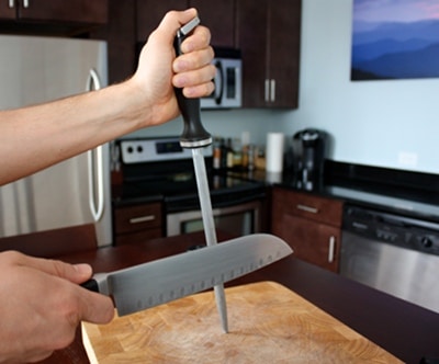 A kitchen knife sharpening with hone.