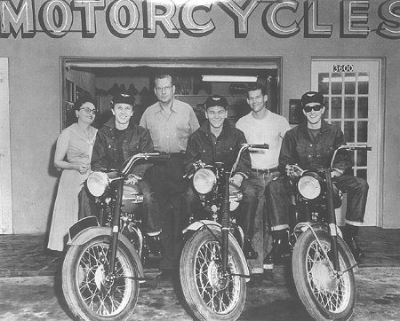 A group photo of riders sitting on motorcycles.