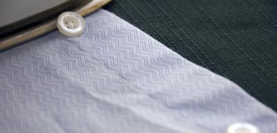 Ironing the front side of dress shirt. 