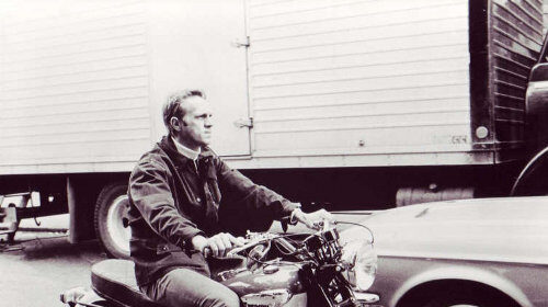 A man sitting on a motorcycle.