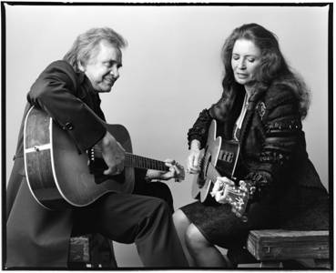 Johnny and June Cash playing guitar. 