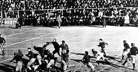 A black and white photo of a football game.