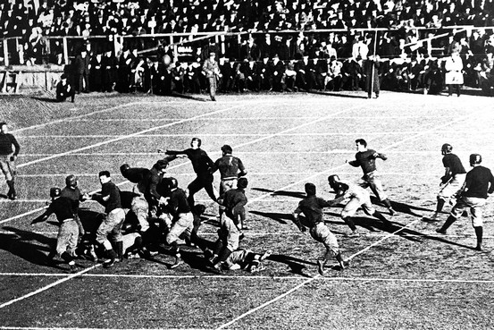 A black and white photo of a football game.