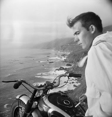 Thompson sitting on motorcycle and looking over the cliff.