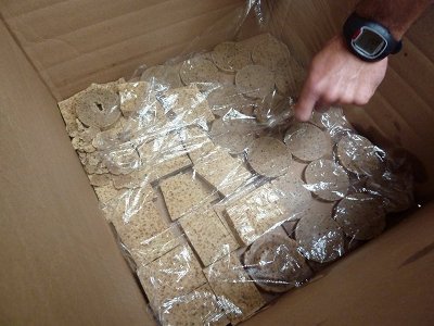 Man placed soap bars in plastic sheet for saponification.