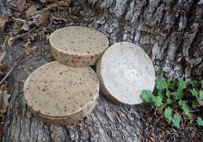 Three manly soap bars sitting on top of a tree.