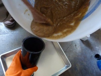 Pouring soap into molds for making homemade soap bars. 