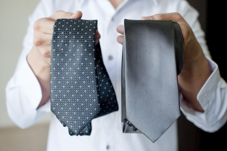 Man showing two different tie pattern. 