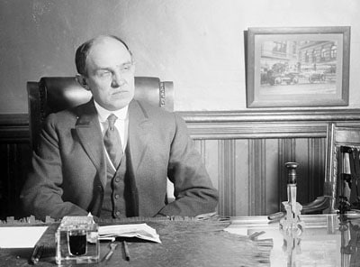 vintage businessman sitting at desk starting sternly