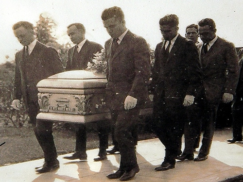 Men carrying casket for funeral. 