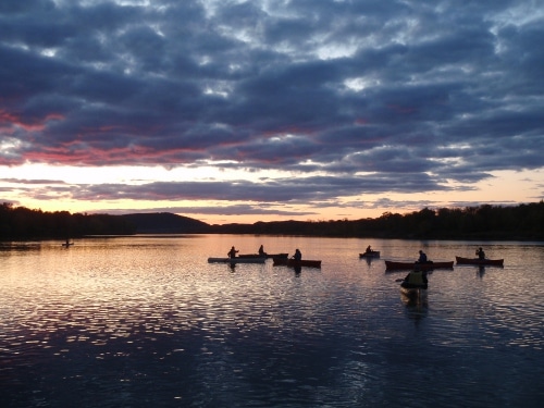 Boats in lake in the evening time.