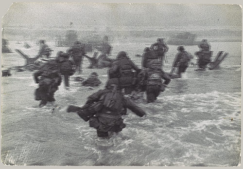 Vintage soldiers military storming beach war.