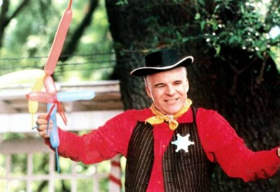 Parenthood movie Steve Martin dressed up and holding balloons.