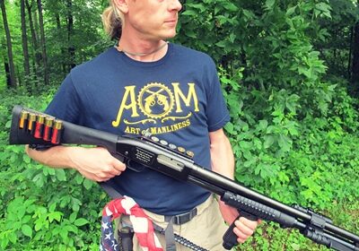 A man armed with the Ultimate Survival Shotgun cautiously navigates through the dense woods, prepared for any potential Zombie Apocalypse.