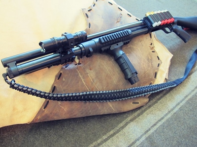 Survival shotgun modified with paracord sling.