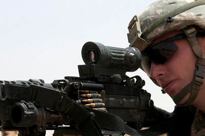 Oakley protective eye-wear on solider aiming gun.