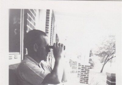 A man using binoculars to find the best way.