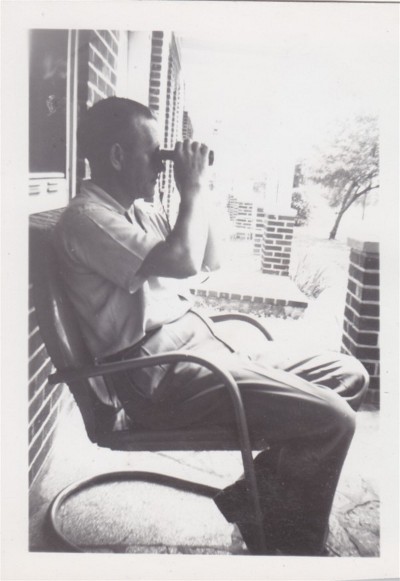 A man using binoculars to find the best way.