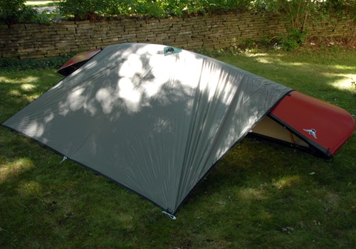 Tarp pitch camping shelter using canoe.