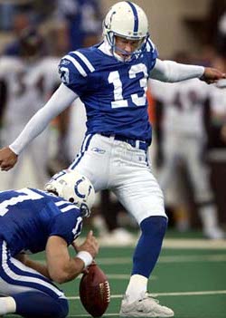 Indianapolis Colts quarterback person kicks the ball during a game, showcasing their clutch skills.