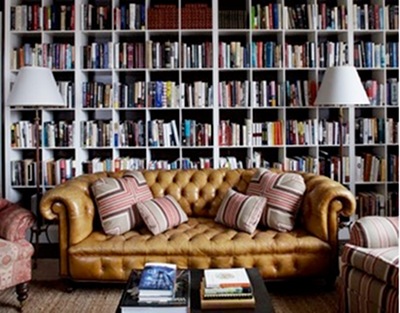 Vintage chesterfield tufted brown sofa in the library.