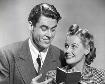 Black and white photo of a man and woman holding a book titled