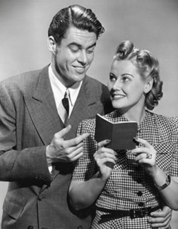 Black and white photo of a man and woman holding a book titled "Young Man's Guide.