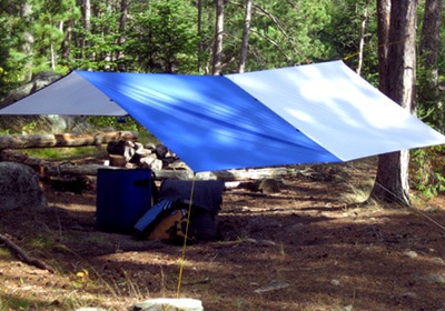 Tarp tent pitch camping shelter protection from elements.