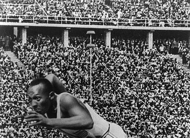Next Level Busting - A black and white photo of a man running on a track.