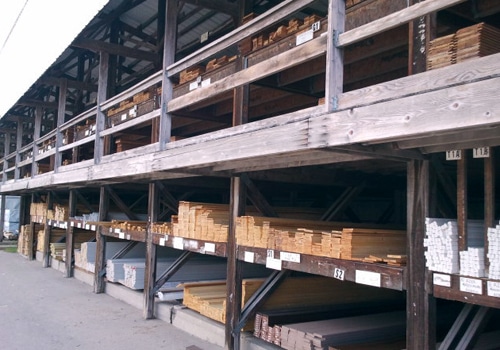 lumber yard shelves filled with board wood 