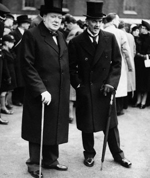 Winston churchill and Neville Chamberlain standing together holding canes.