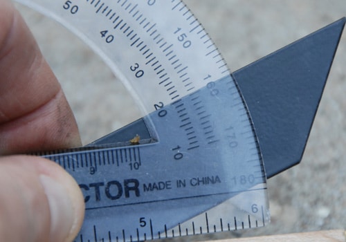 Triangle sharpener measuring angle with protractor. 