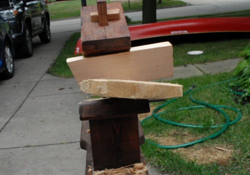 A canoe paddle on the stand and water pipe on the grass are being displayed. 