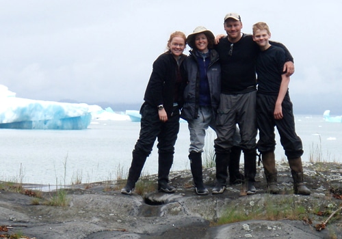 A family standing on a rock.