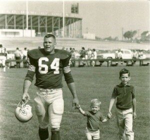 A dignified black and white photo capturing a football player celebrating with his son.