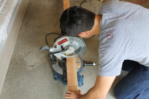 Cutting wood for DIY homemade sawhorse for garage.