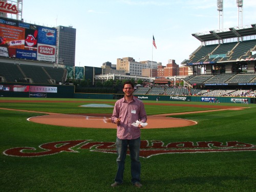 Man standing in baseball stadium. 