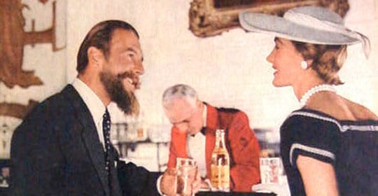An educated man and woman conversing at a bar.