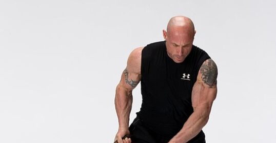 A man is holding a Bulgarian Training Bag in front of a white background.