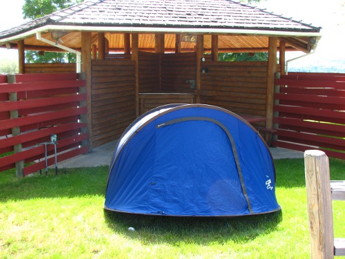 A survival camp is placed on grass.